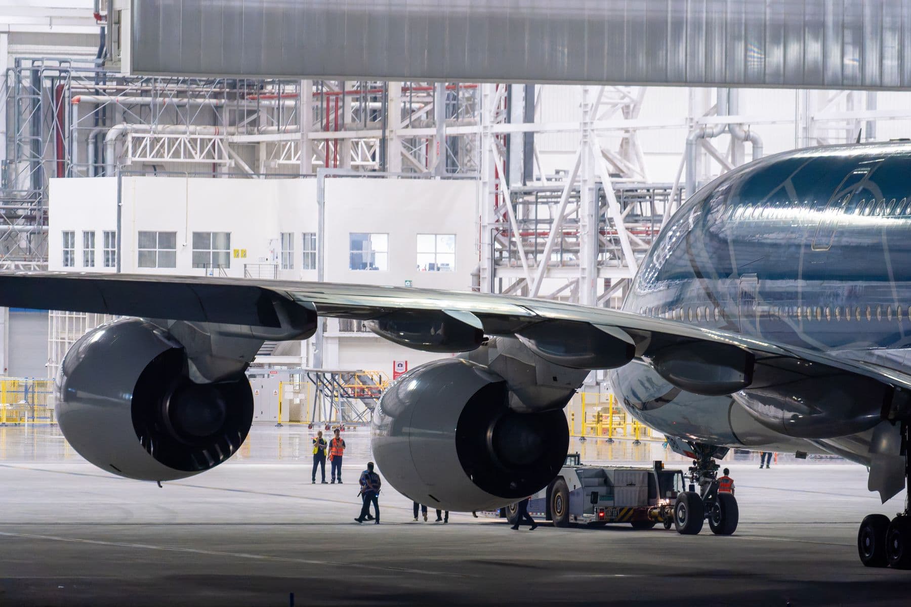 Widebody aircraft undergoing technical work inside a maintenance hangar